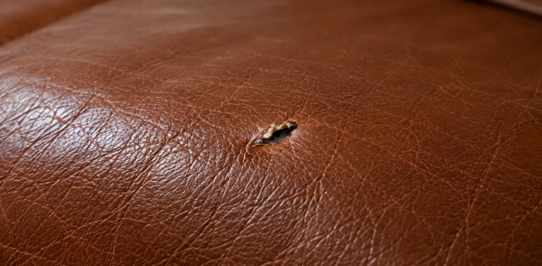 Stage one: a small puncture in a brown leather seat cushion