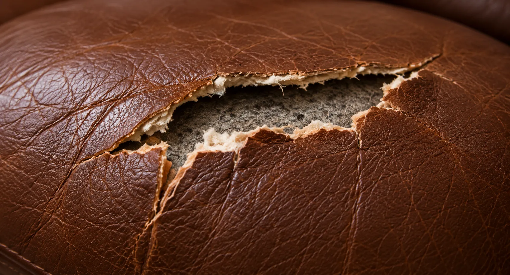 Stage four: a large rip across the cushion with the leather distorted around it