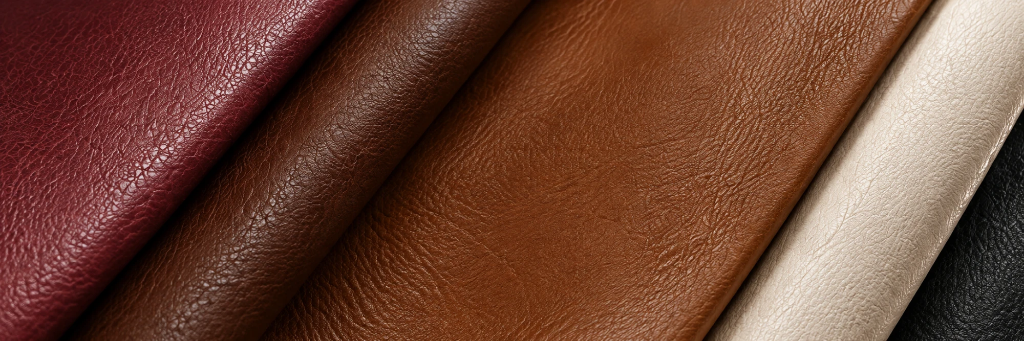Folded leather hides fanned out in cognac, cream, burgundy and black