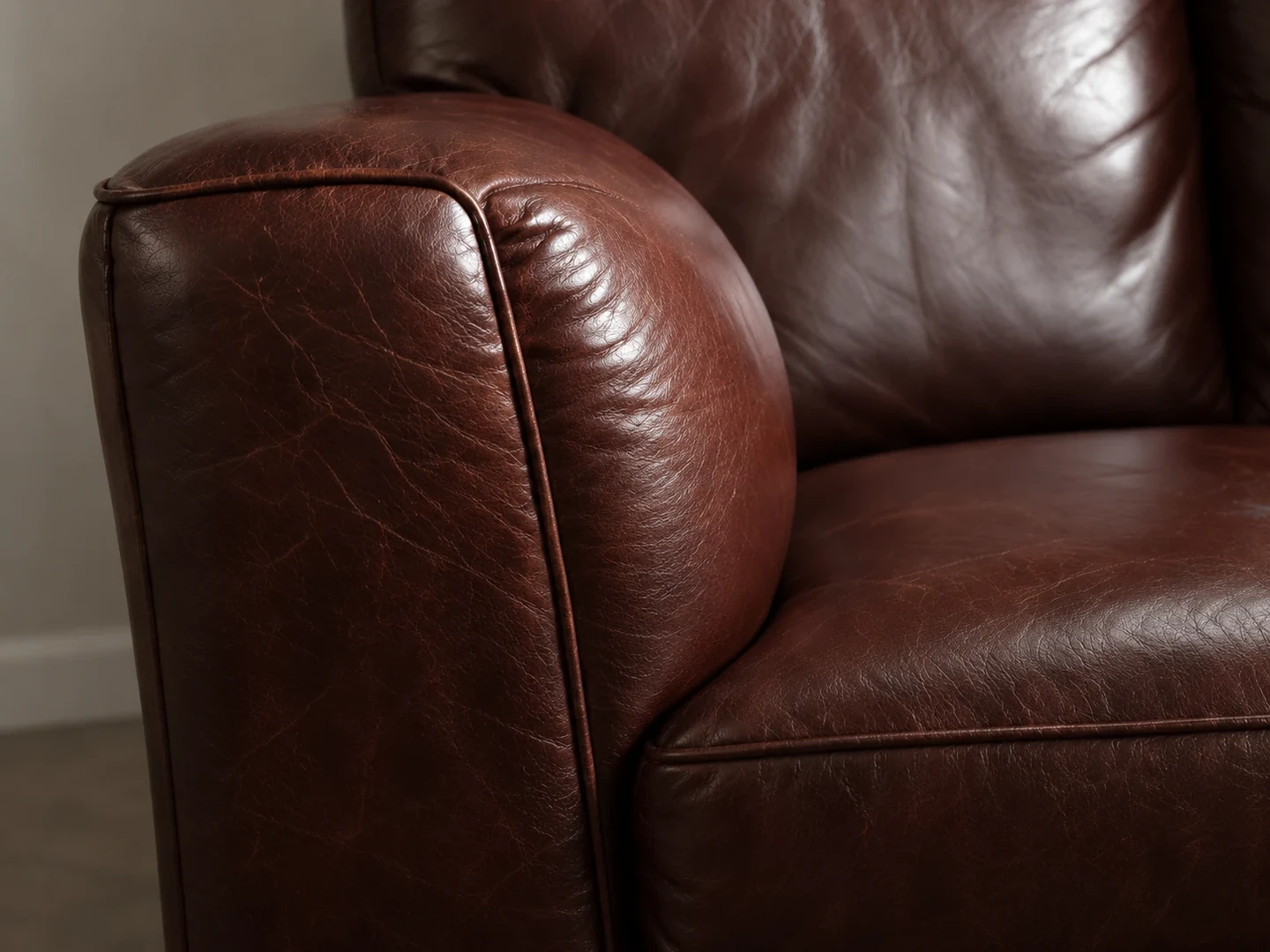 Brown leather club chair arm and seat
