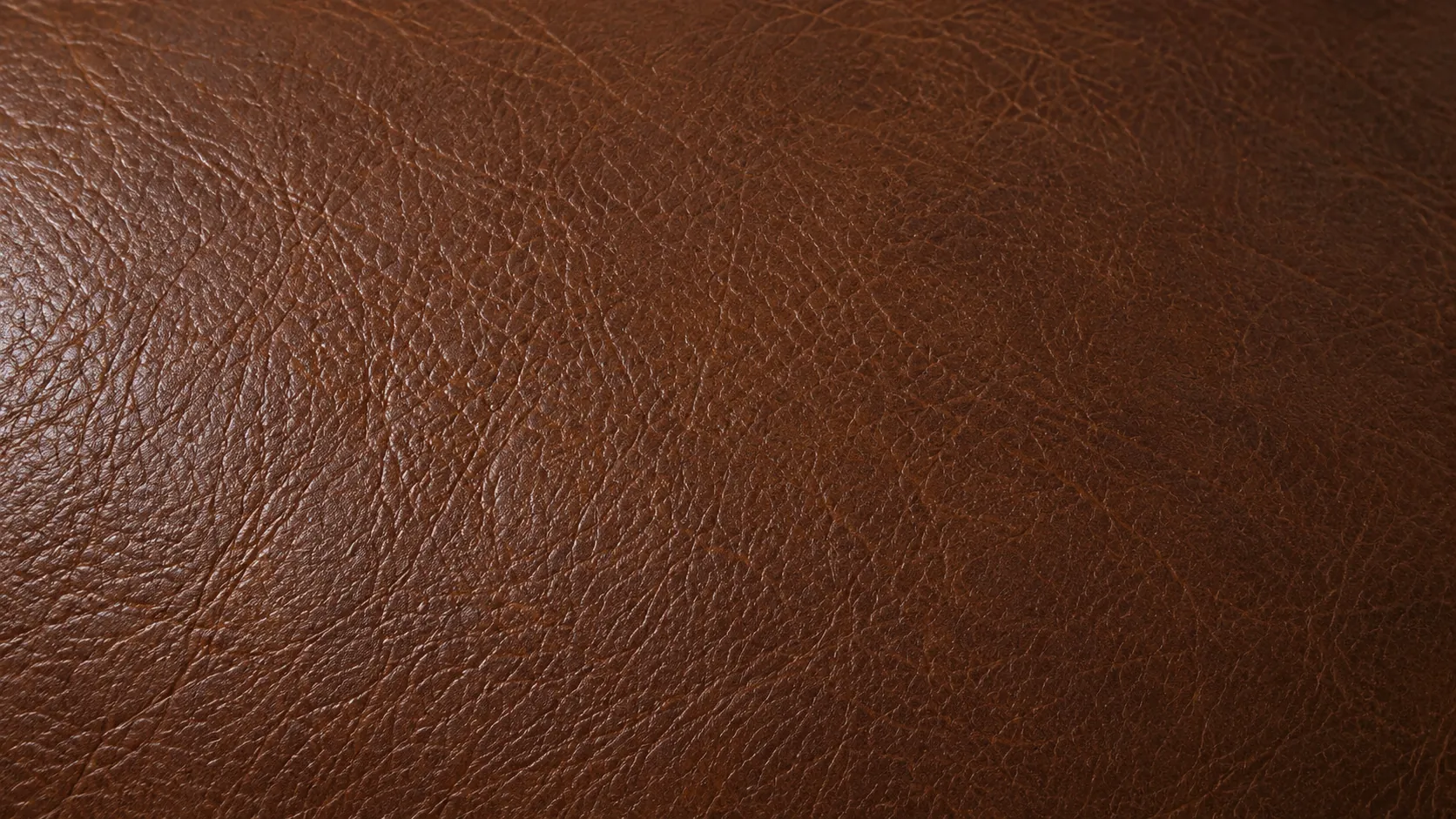 The finished brown leather panel with colour and sheen matched across the repaired area