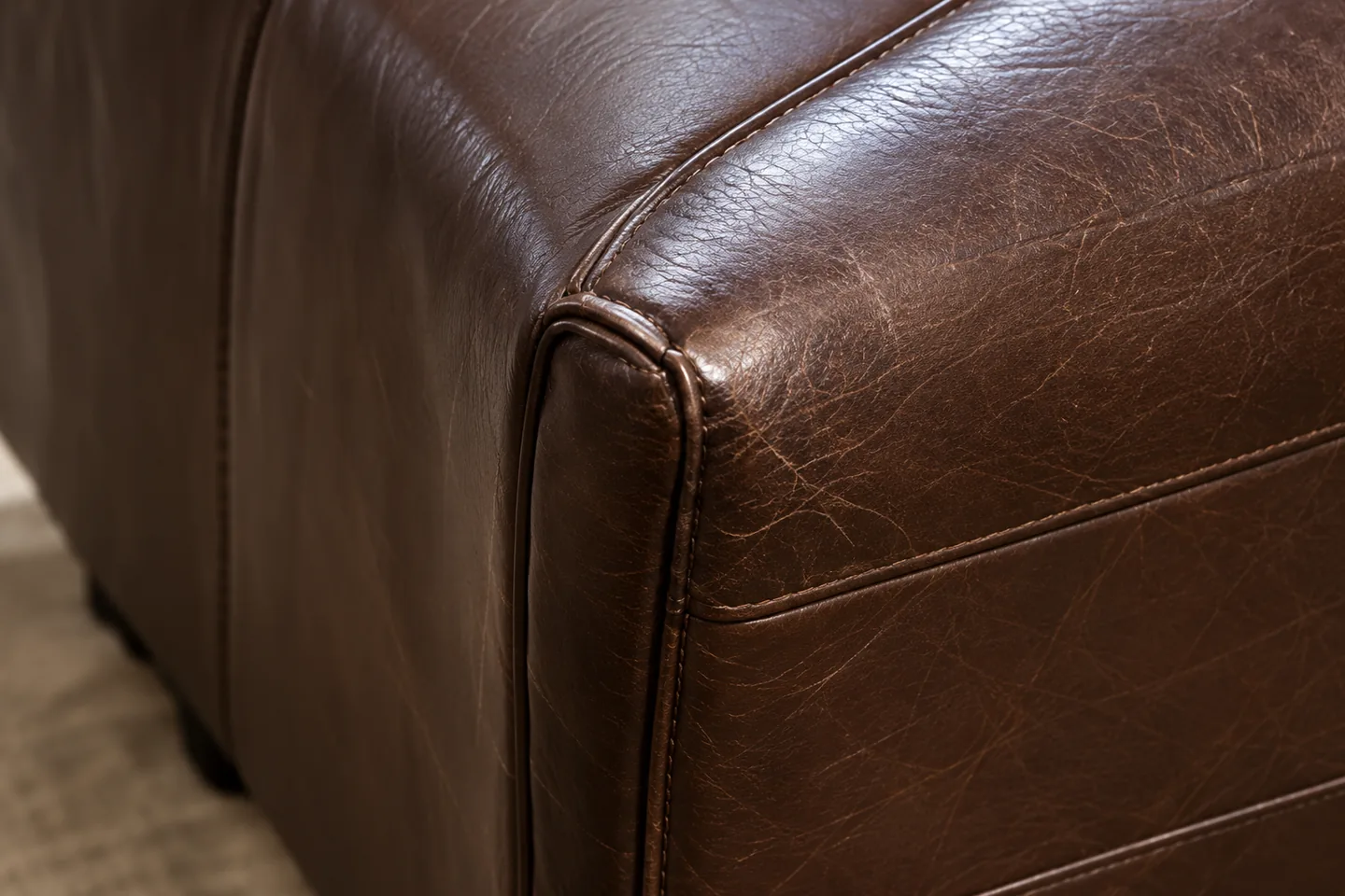 A scuffed outside arm panel with the leather underneath still sound