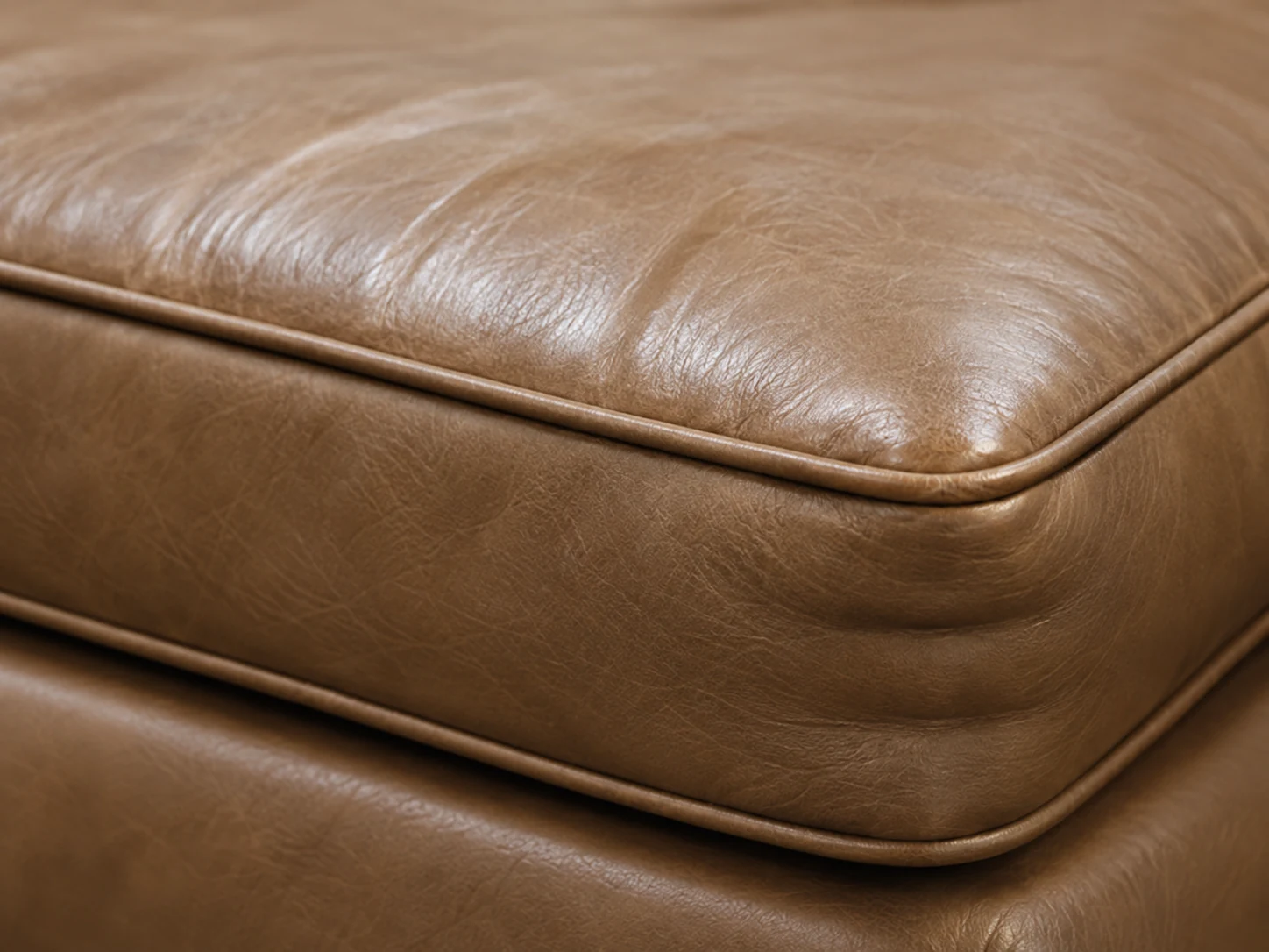 Restored brown leather seat cushion corner with even seams and a square edge