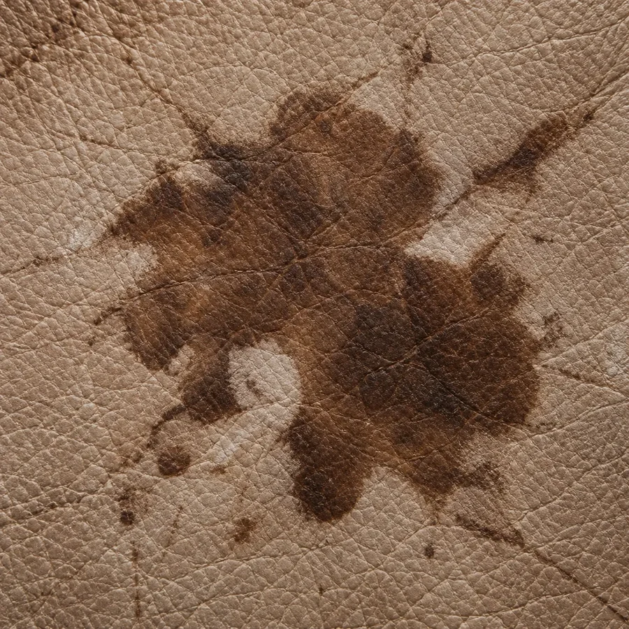Close-up of a dark stain soaked into brown leather