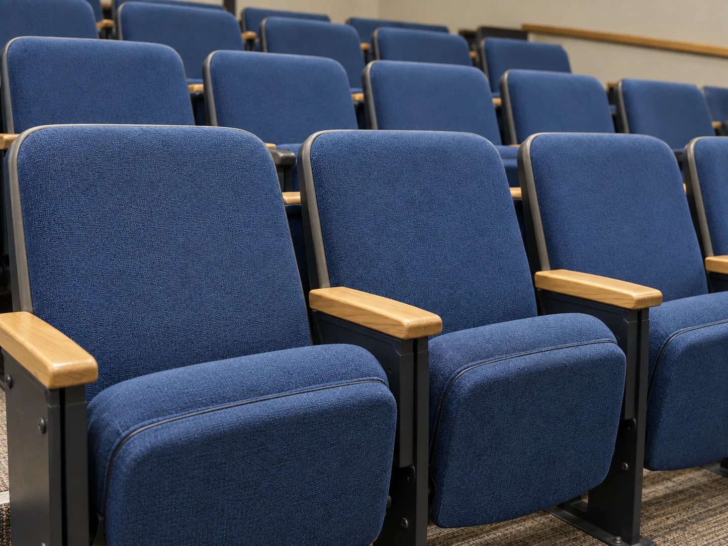 The same lecture hall seats in clean navy fabric