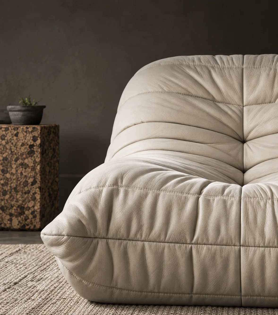 Cream leather sofa with ribbed quilted panels and no frame