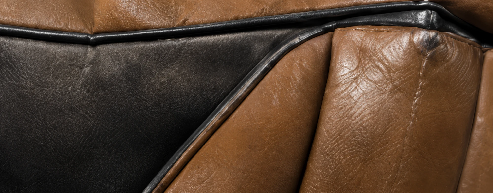 Assessing a leather panel and its piping on a Ligne Roset piece