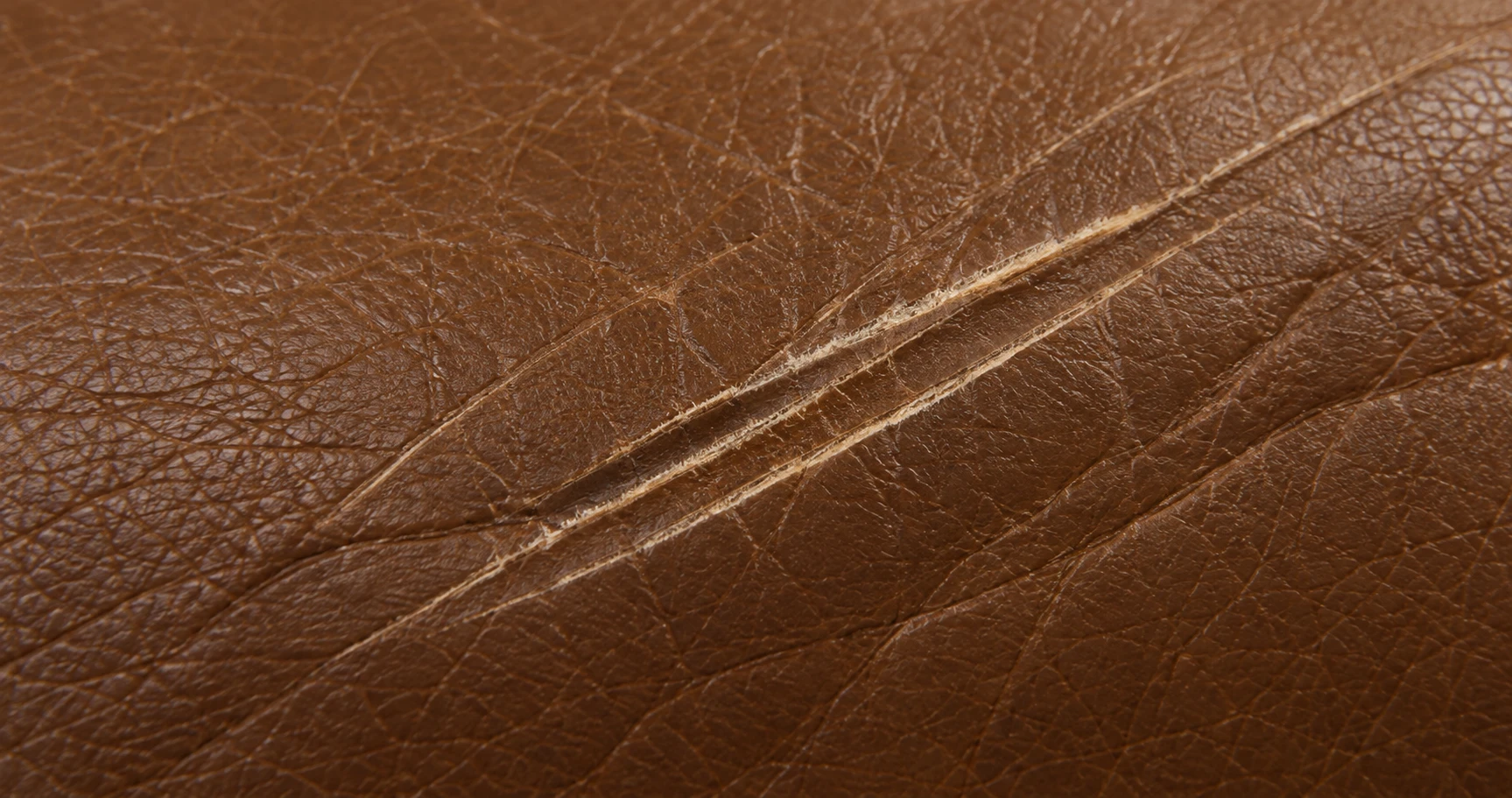 Scratches across brown Ligne Roset leather