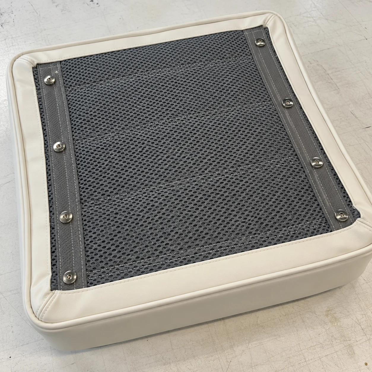 The vented mesh underside of a finished boat cushion