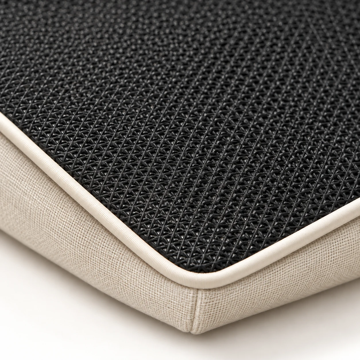 Black mesh drainage panel set into the underside of an outdoor cushion
