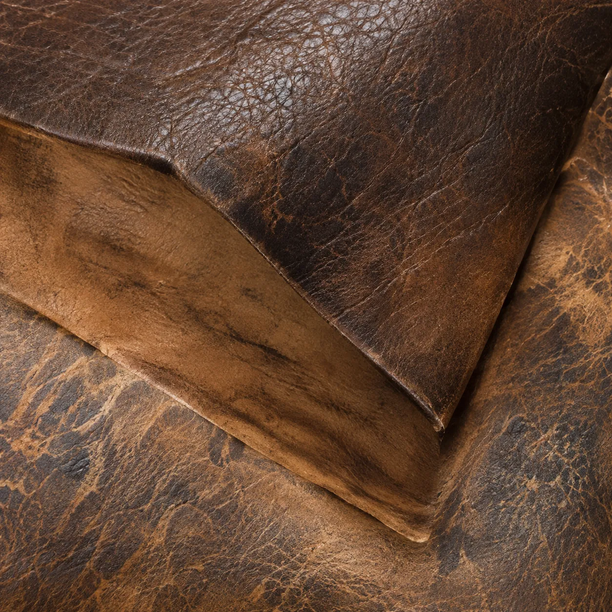 Distressed brown pull-up leather swatch with waxy tonal variation across the grain