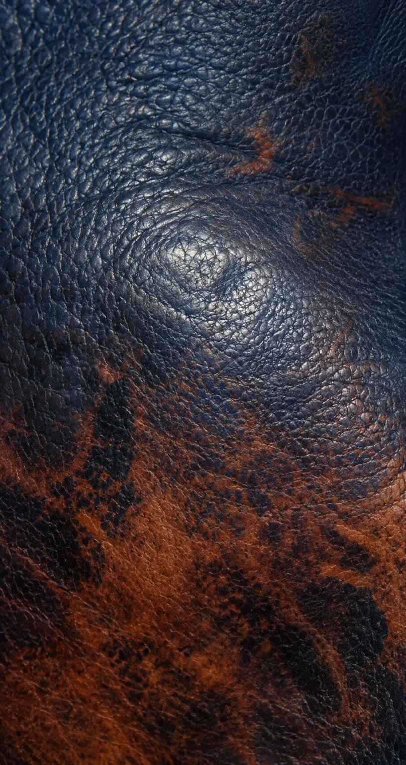 Navy leather marked with stains and worn color