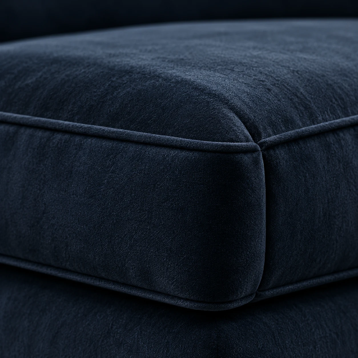 Navy velvet boxed chair cushion with a welted edge and boxing band