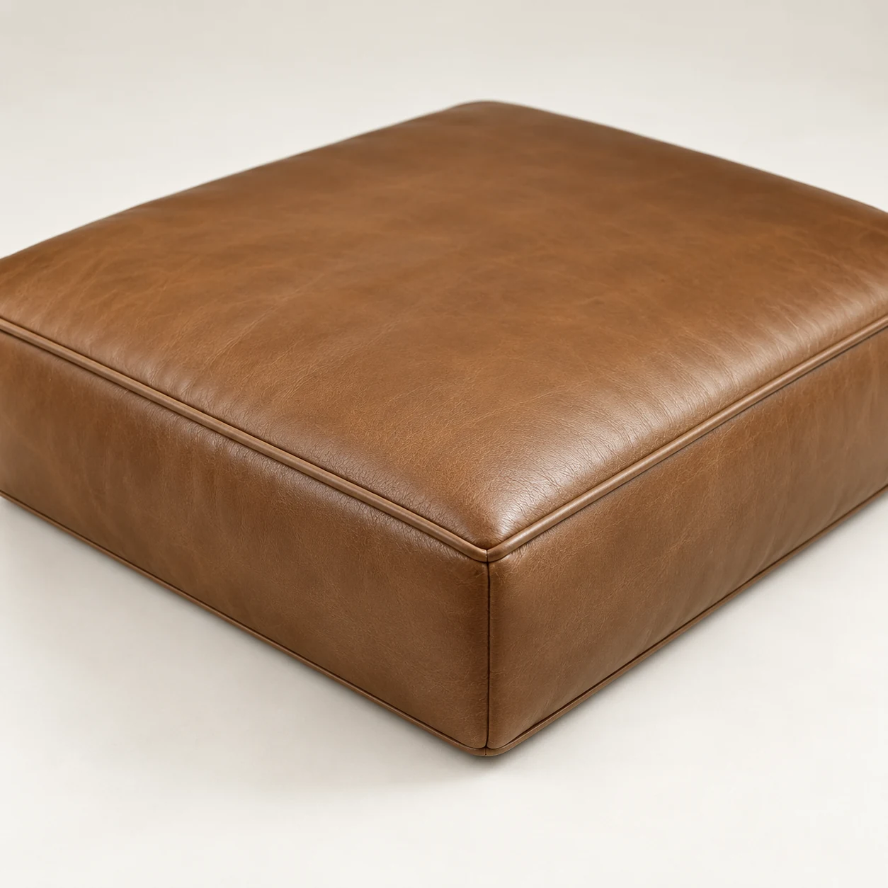 New brown leather cushion cover fitted over a rebuilt core
