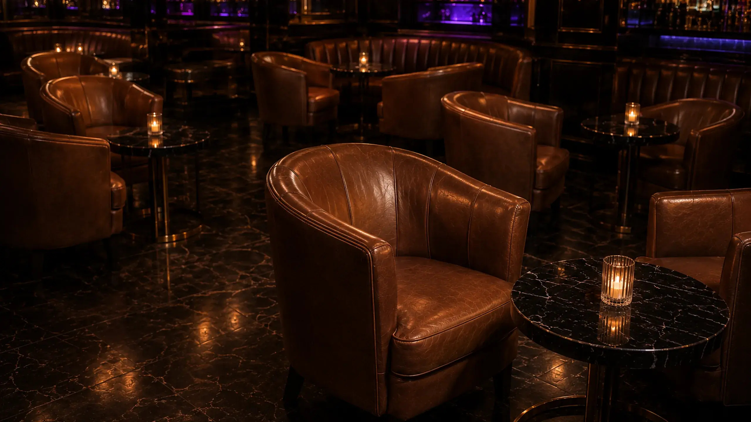 Cognac leather club chairs and marble tables in a nightclub lounge