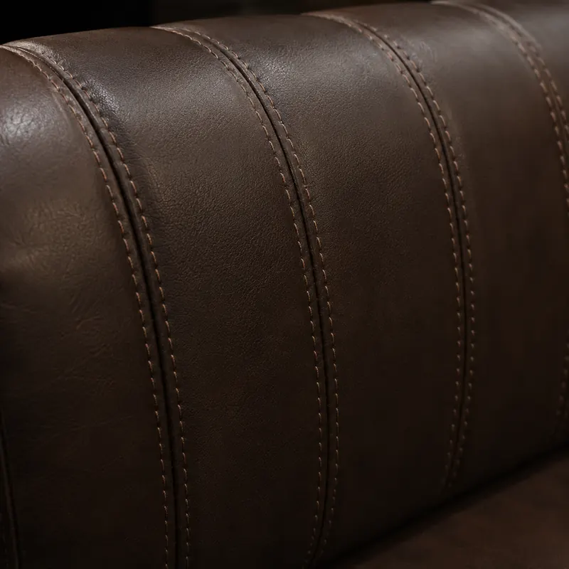 Decorative twin-needle topstitching on a brown leather arm roll