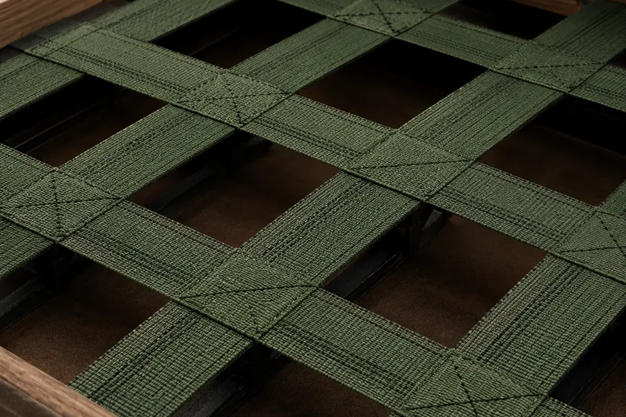 Sagging webbing and springs exposed under a stripped banquette seat