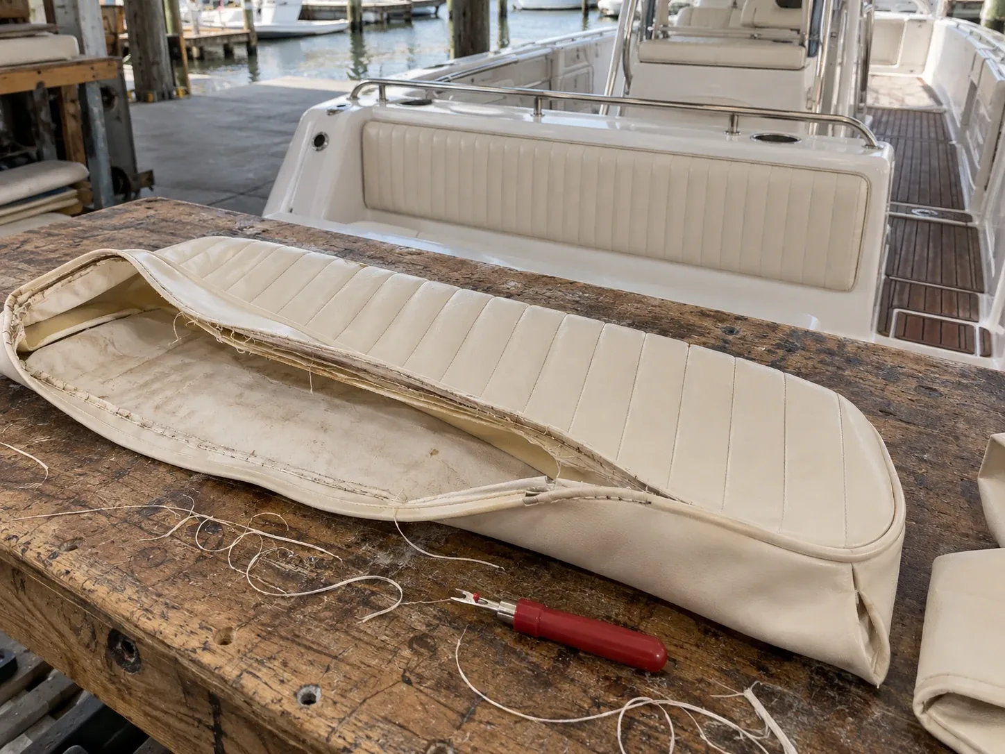 An old boat cover unpicked seam by seam on a workbench