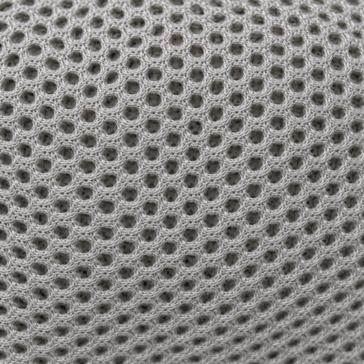 Macro of open mesh drainage fabric used in an outdoor cushion base