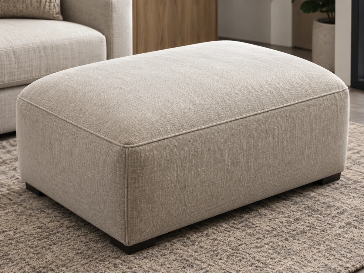 Beige fabric ottoman with a single boxed cushion top