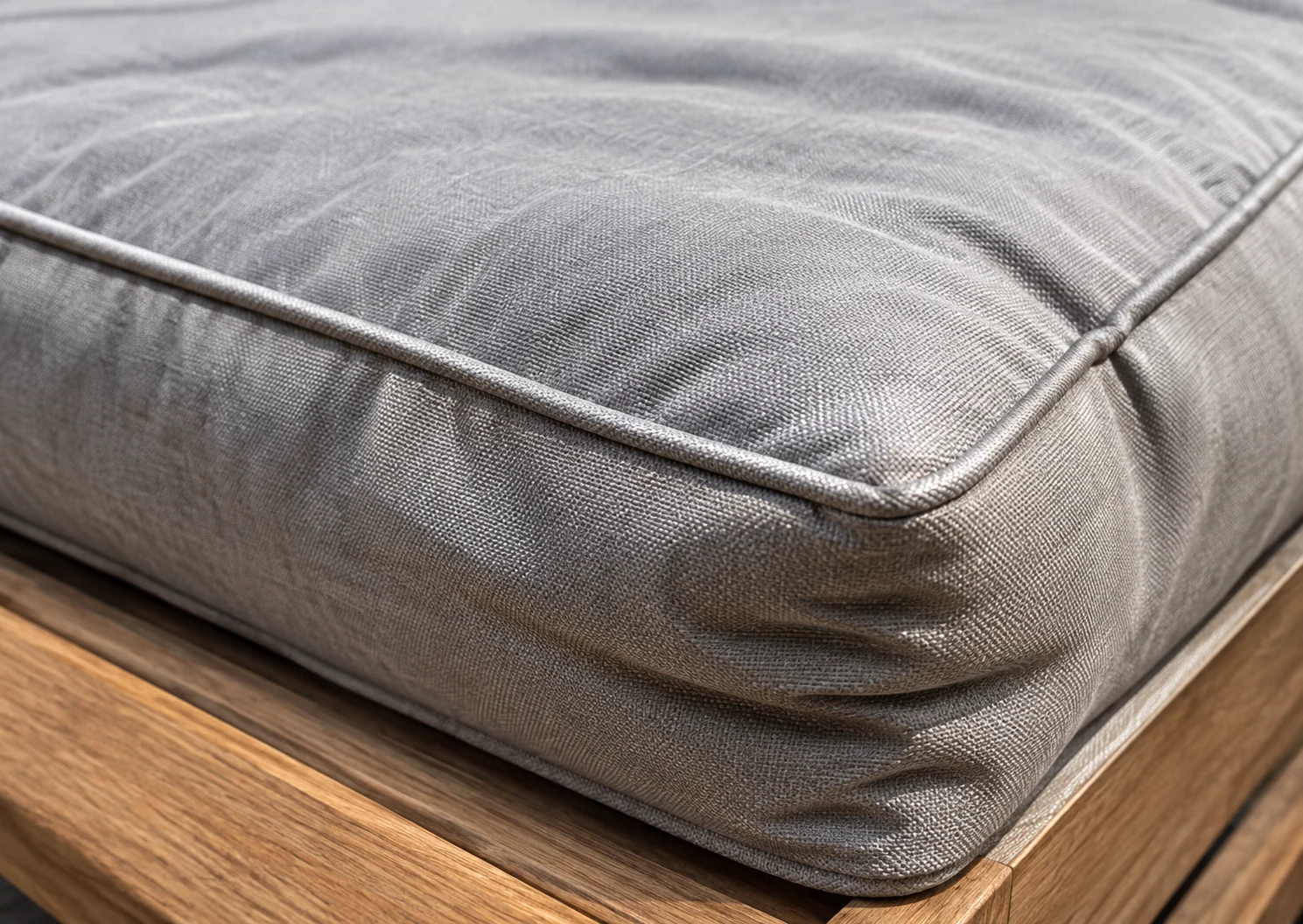 Loose creased outdoor cushion cover sitting slack over a shrunken core