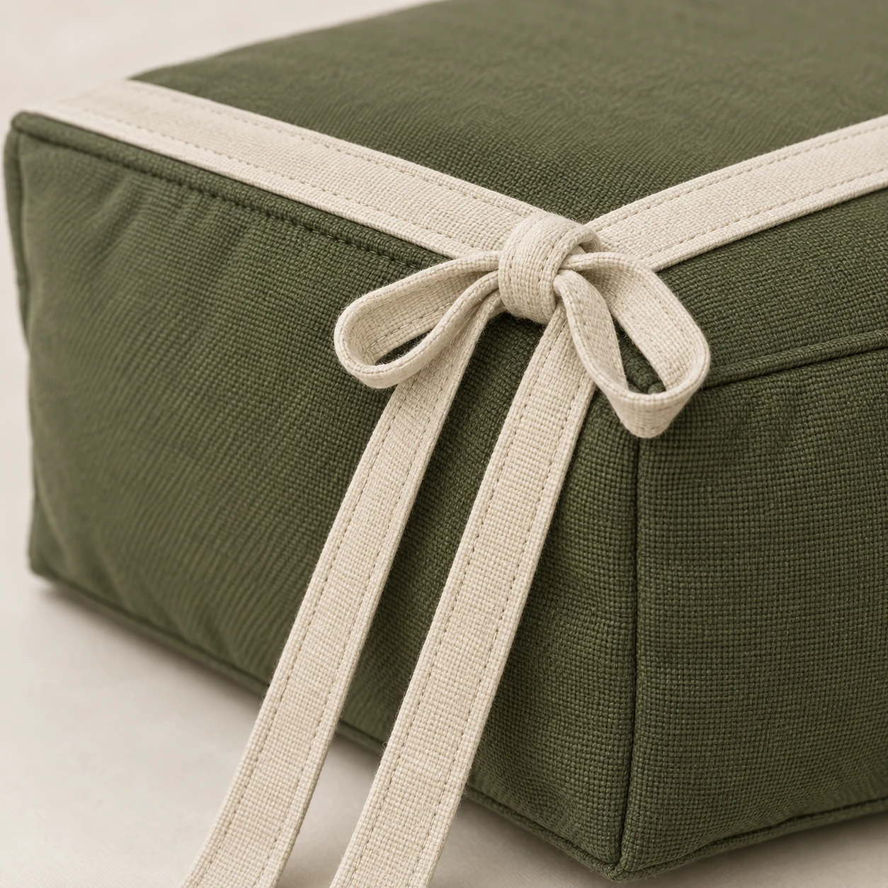 Green outdoor seat pad tied onto a chair frame