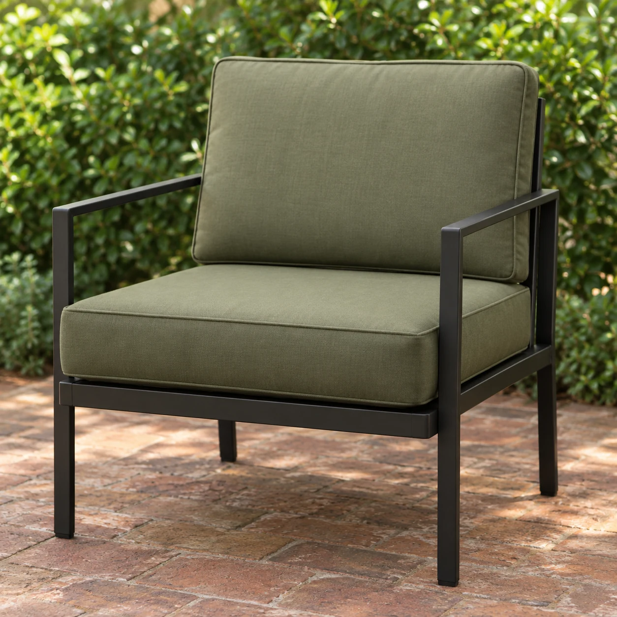 Green outdoor seat pads on a steel-frame terrace lounge chair