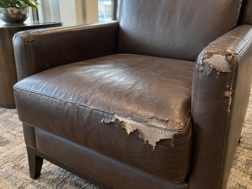 Faux leather peeling off an amenity room armchair