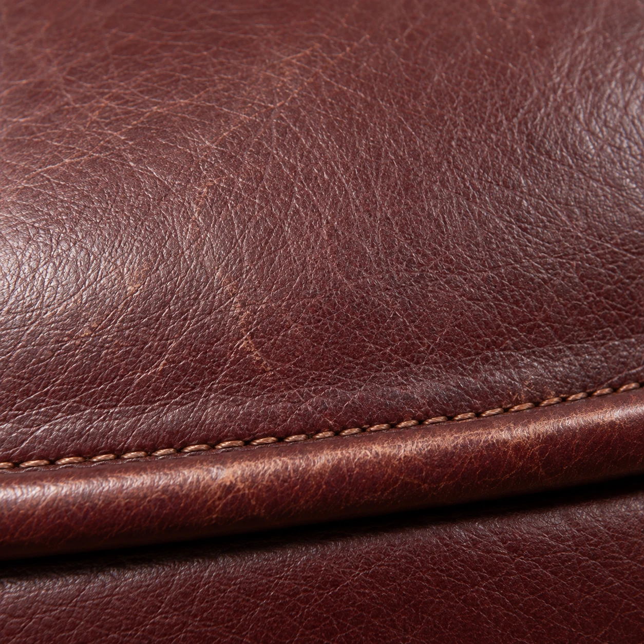 Stitched corner detail on oxblood leather