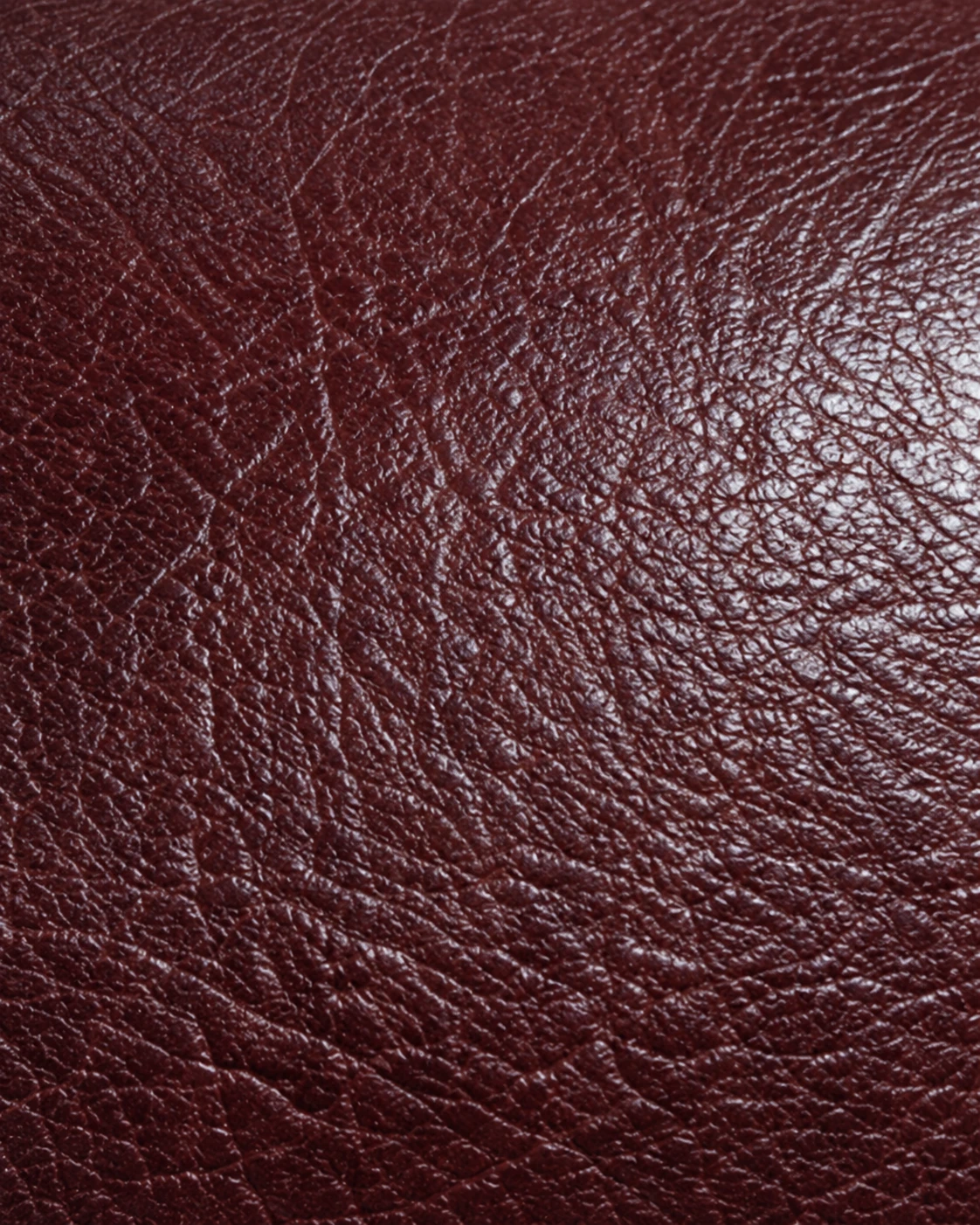 Natural grain and soft sheen on oxblood aniline leather