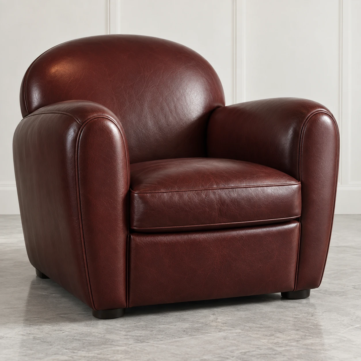 Oxblood leather club chair photographed for a restoration quote