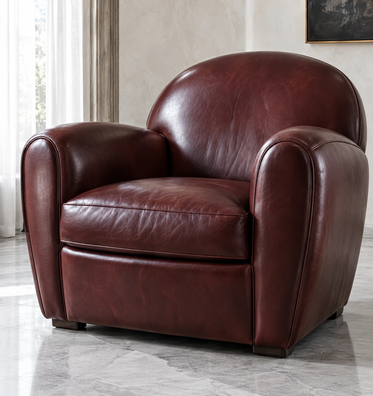 Oxblood leather club armchair on a marble floor