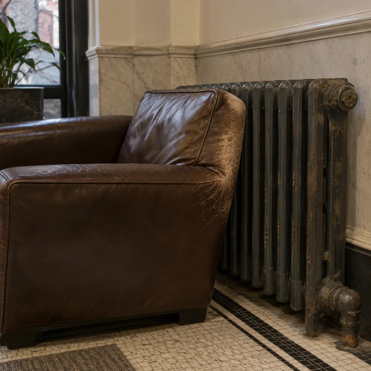 A leather chair left standing against a radiator