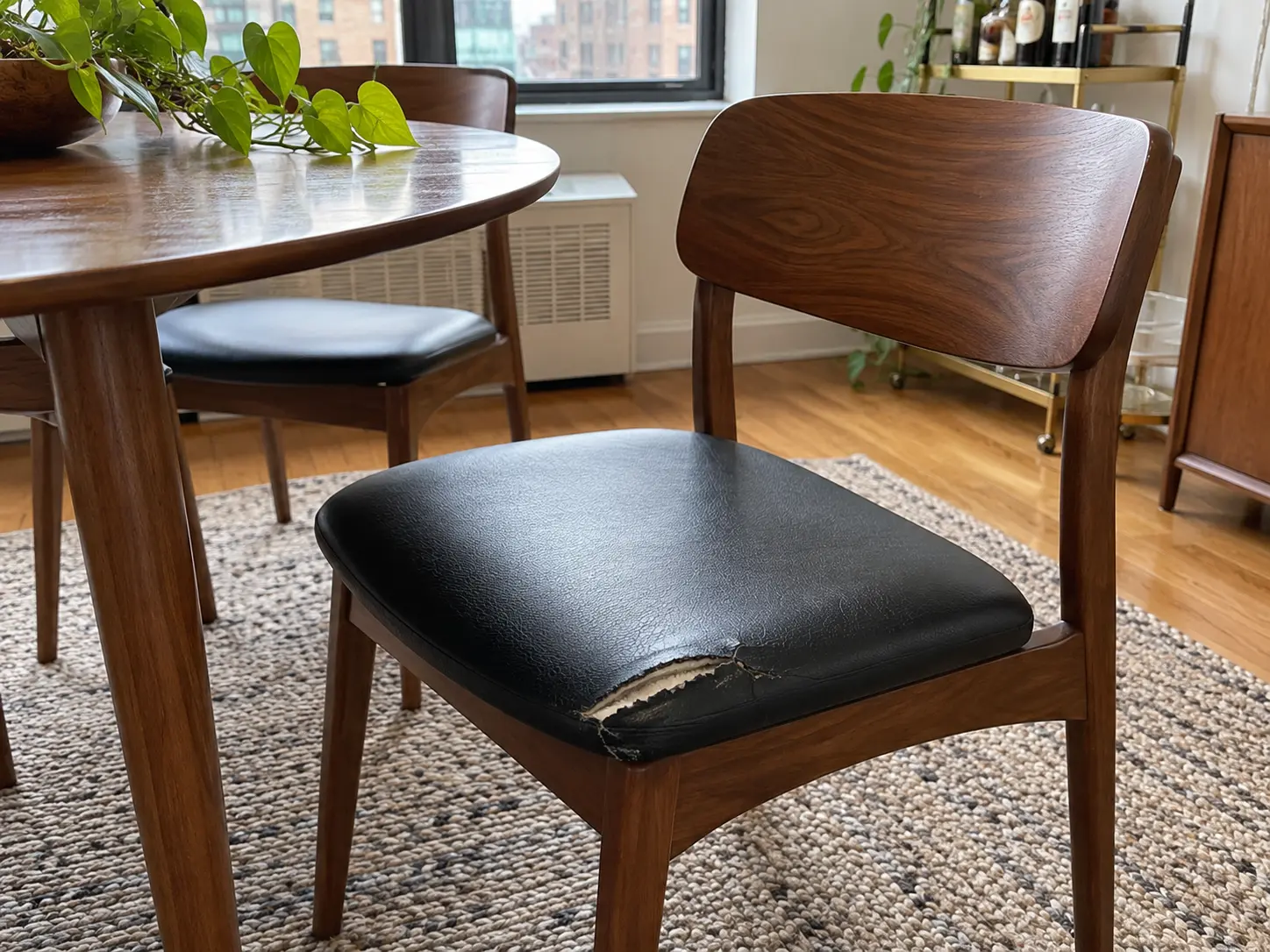 A rental dining chair before repair