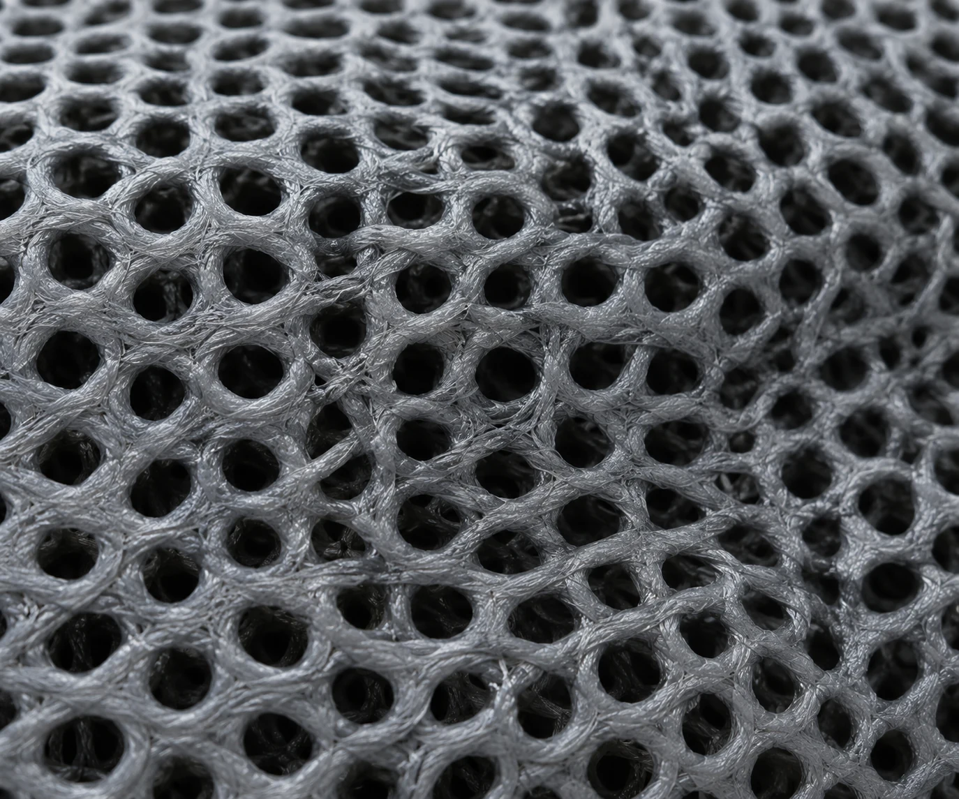 Macro of reticulated drain foam showing the open lattice that lets water pass through
