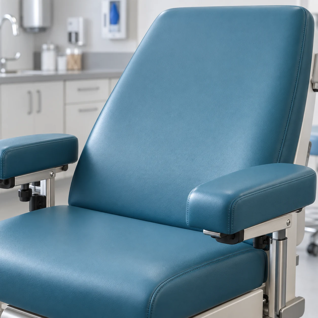 Procedure chair reupholstered in teal vinyl
