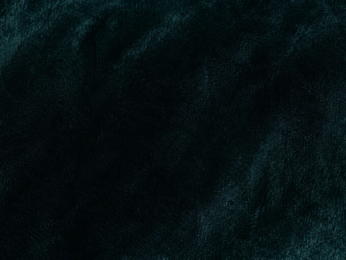 Dark teal velvet with a short dense pile that shades as it catches the light