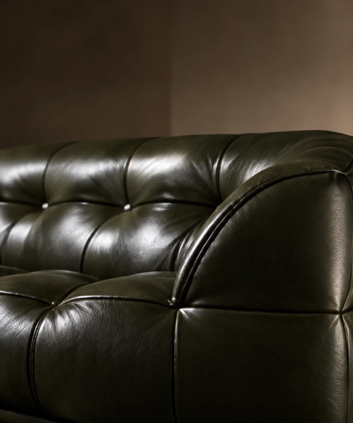 Deep green tufted leather sofa