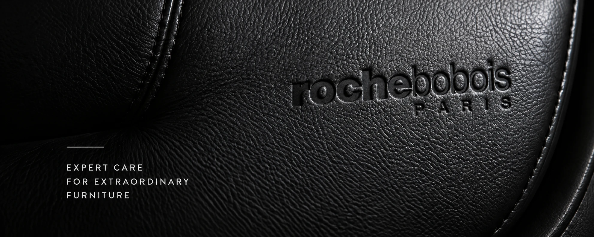 Black pebbled leather embossed with a Roche Bobois Paris nameplate, captioned expert care for extraordinary furniture