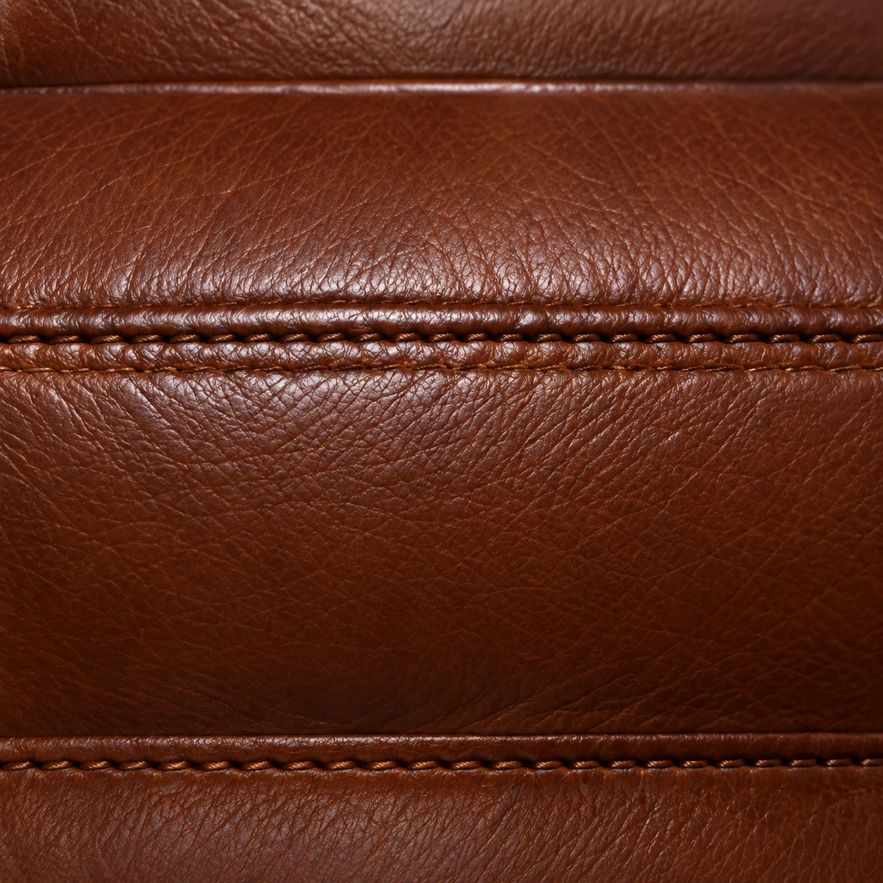 Two parallel stitched seams running across a brown leather panel after restitching