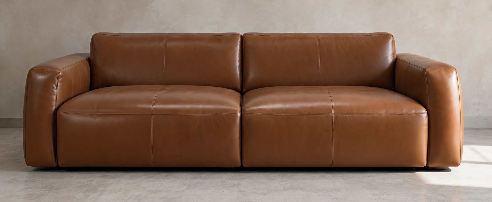 The same sofa after repair, the leather smooth and evenly coloured across every panel and cushion