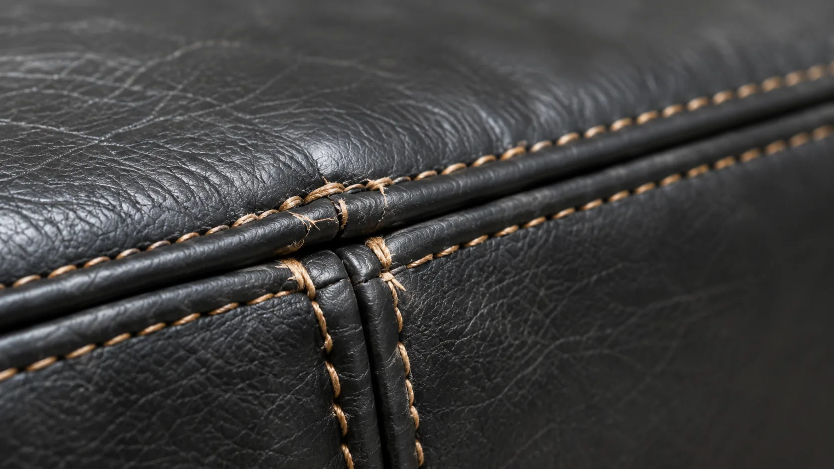 Contrast stitching along a black leather seam