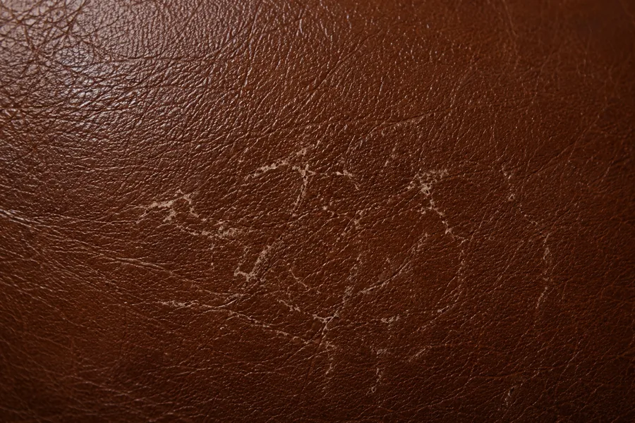 Brown leather with a roughened, broken finish where the surface has been abraded