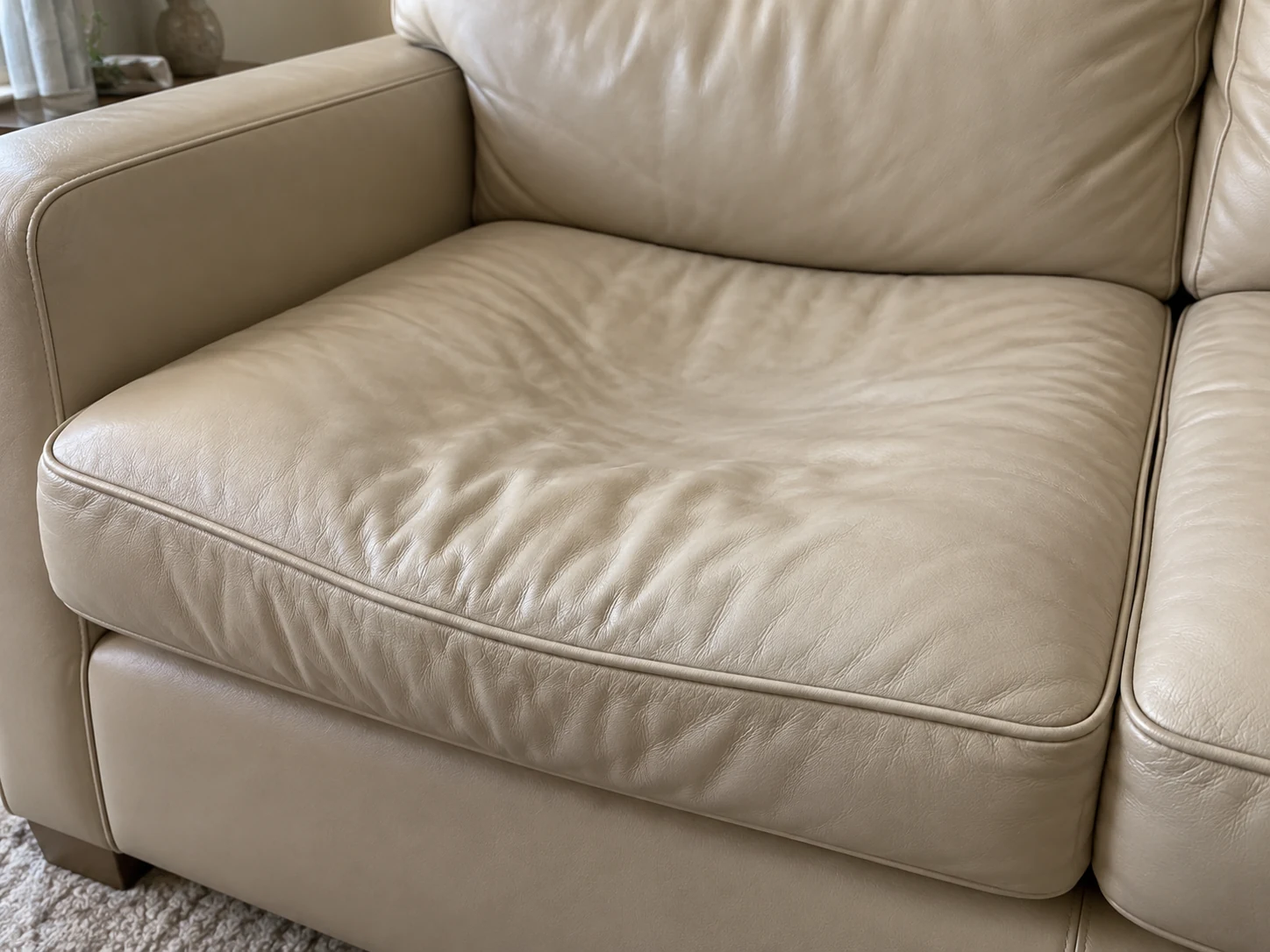 Sagging armchair seat cushion sitting low in the frame