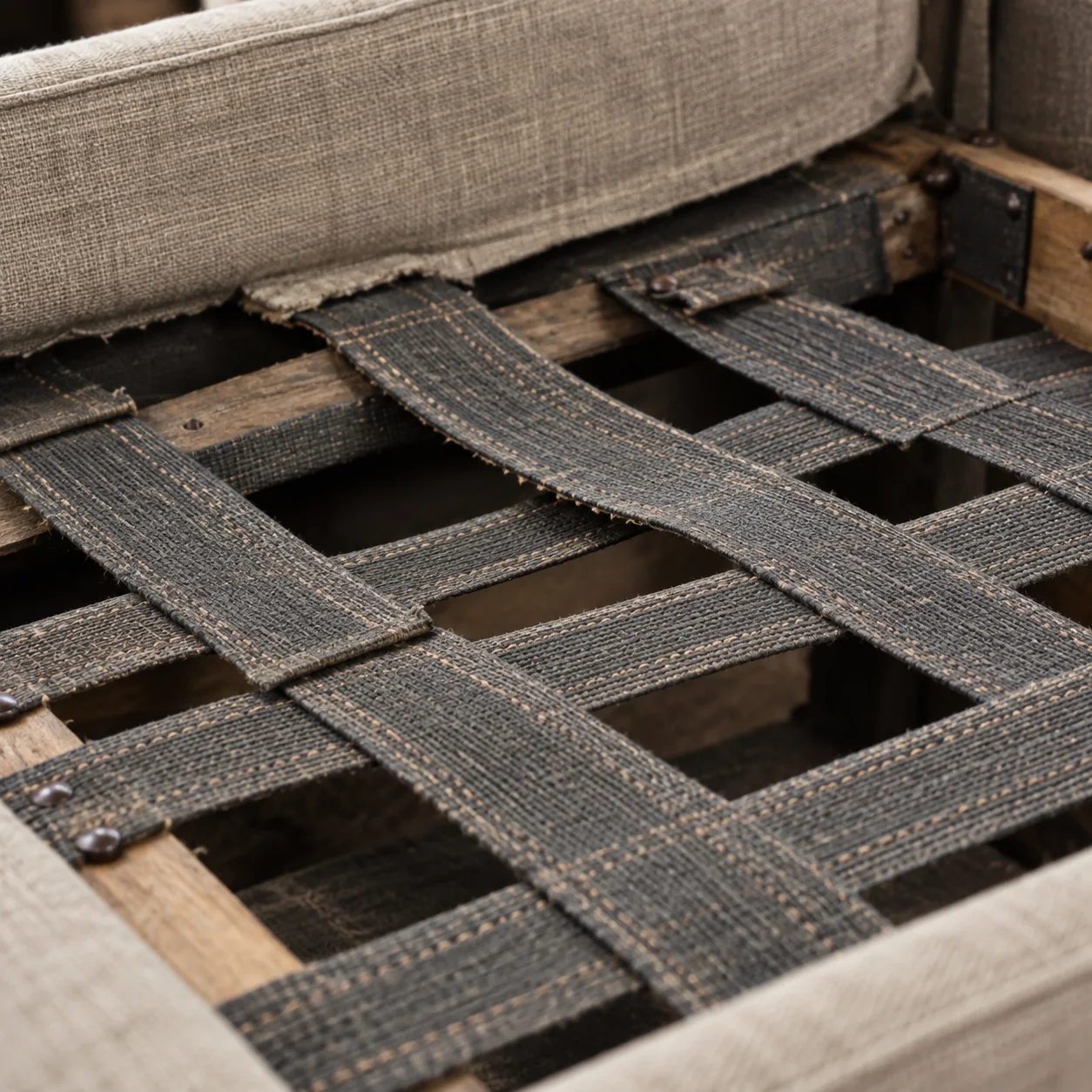 Sagging webbing seen from under a stripped dining chair seat