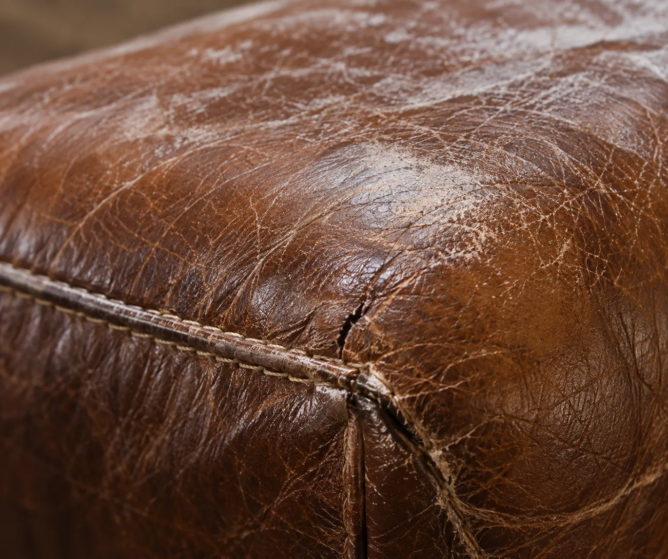 Dark brown bench corner split open at the junction of three panels