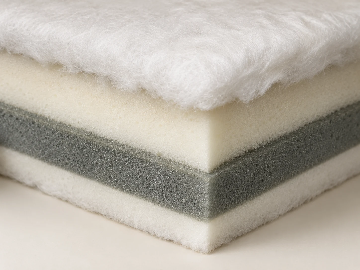 Cutaway of a seat cushion showing the foam core, fiber wrap and outer cover