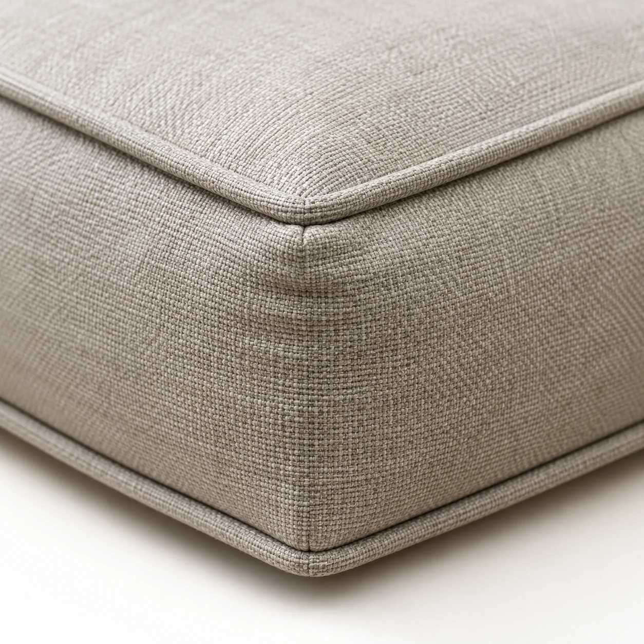 Self-welt corner on a beige boxed outdoor cushion