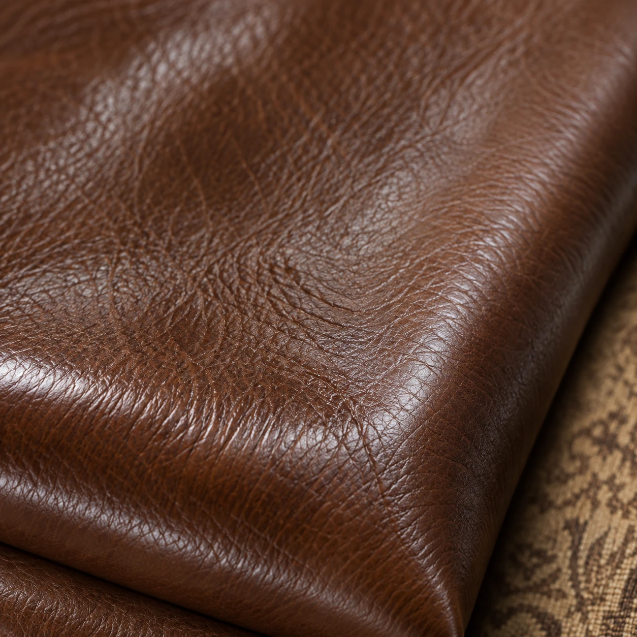 Warm brown semi-aniline leather swatch showing natural grain under a thin finish