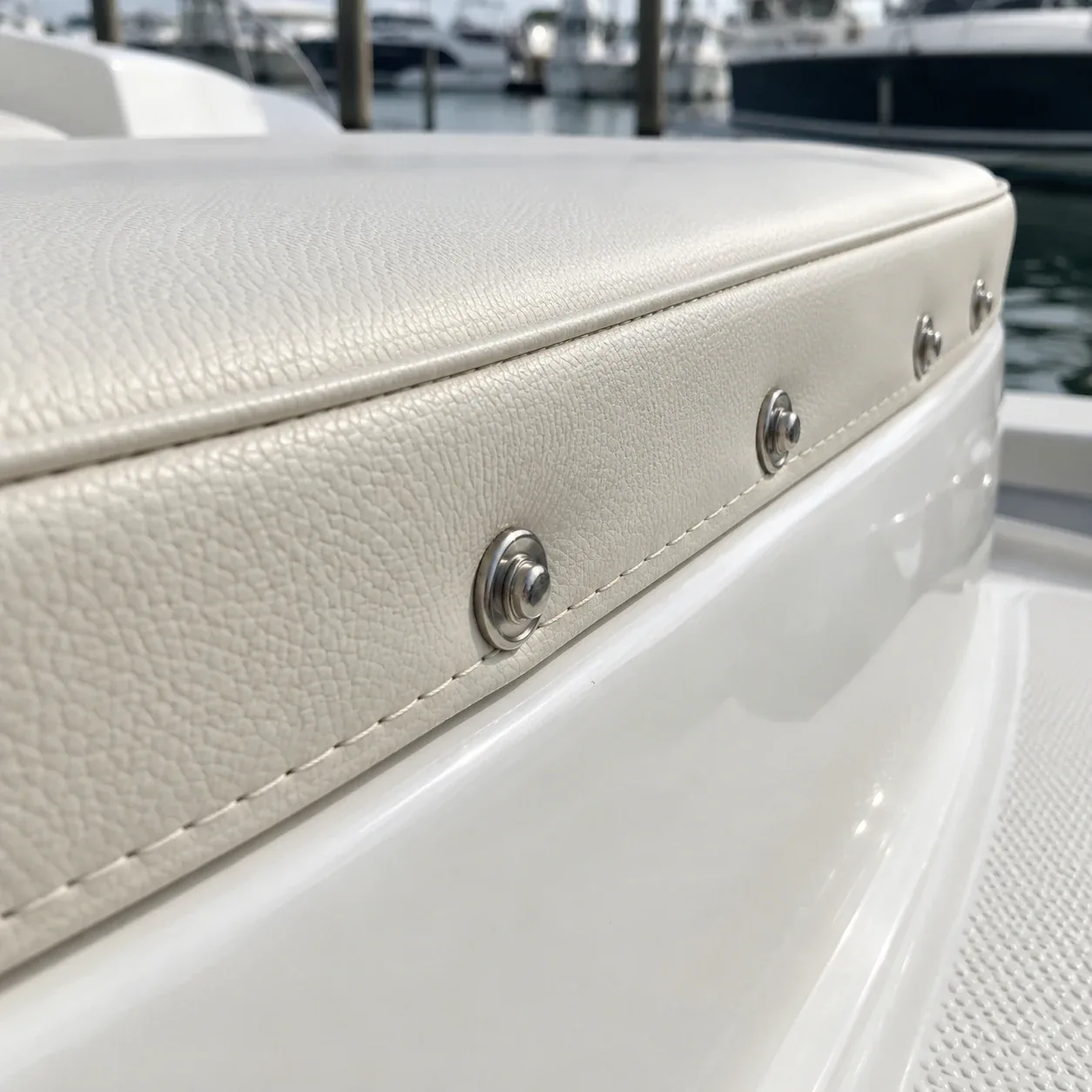 A line of snap fasteners set along the edge of a boat cushion cover
